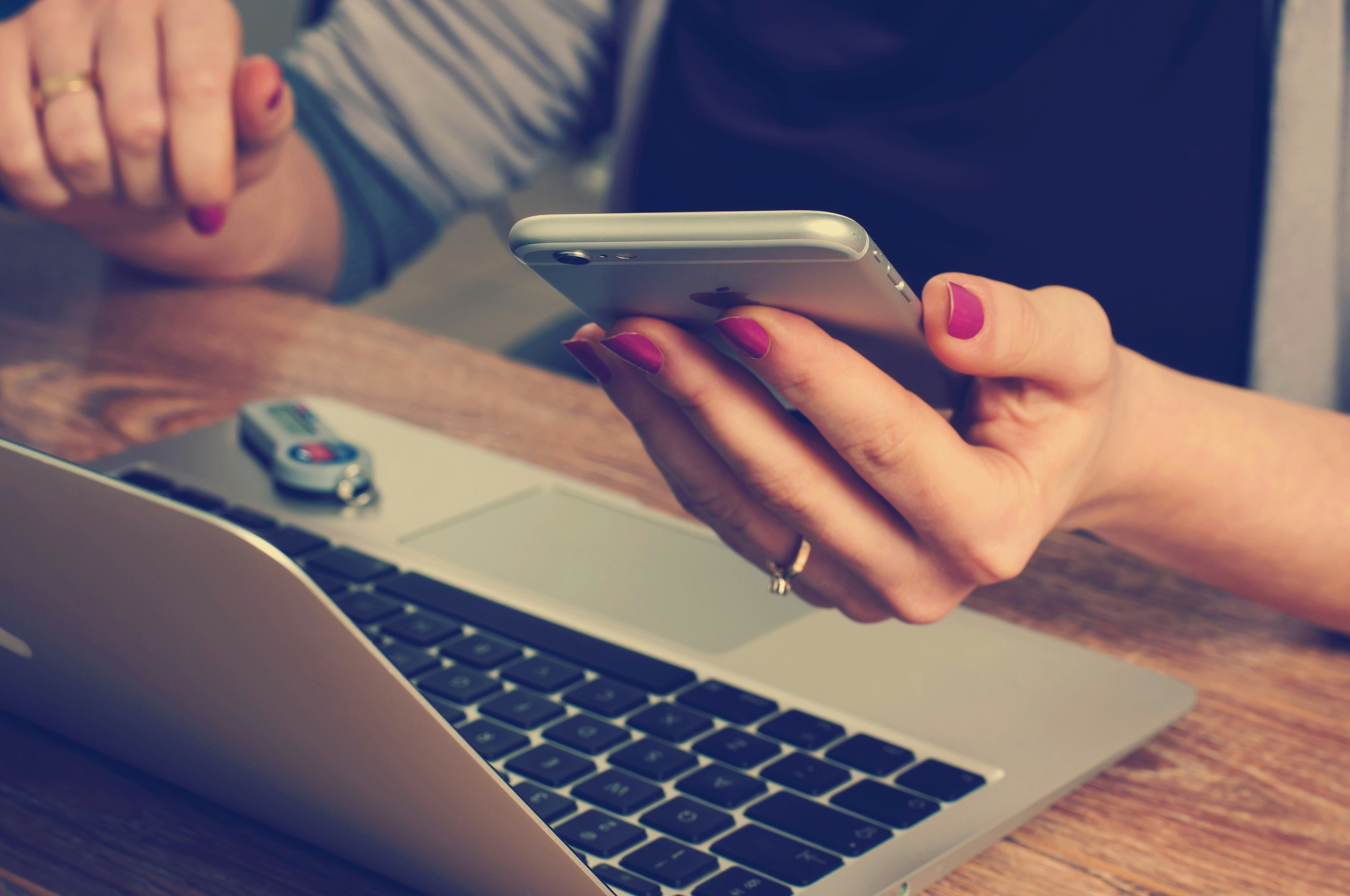 Female Holding a phone in front of the computer